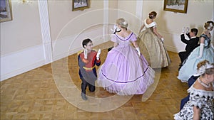 Young couple is dancing in the living room. The couple is dancing in old clothes.
