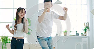 Young couple  dancing in living room at home