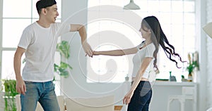 Young couple  dancing in living room at home