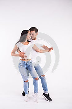 Young couple dancing social latin dance bachata, merengue, salsa. Two elegance pose on white background