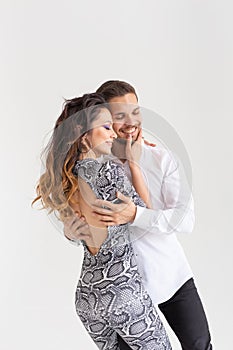 Young couple dancing social latin dance bachata, merengue, salsa. Two elegance pose on white background