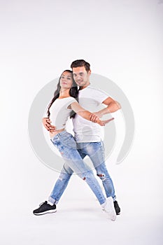 Young couple dancing social latin dance bachata, merengue, salsa. Two elegance pose on white background