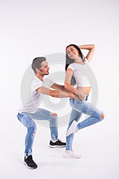 Young couple dancing social latin dance bachata, merengue, salsa. Two elegance pose on white background