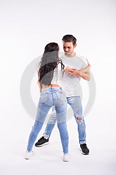 Young couple dancing social latin dance bachata, merengue, salsa. Two elegance pose on white background