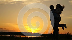 Young couple dancing at sunset on beach. Happy guy and girl waltz in evening in the summer park. Loving man and woman