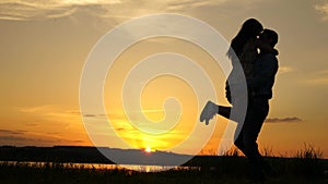 Young couple dancing at sunset on beach. Happy guy and girl waltz in evening in the summer park. Loving man and woman