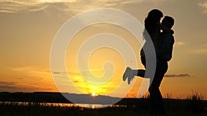 Young couple dancing at sunset on beach. Happy guy and girl waltz in evening in the summer park. Loving man and woman