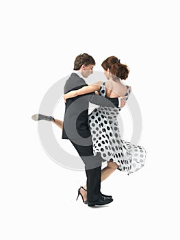 Young couple dancing the tango, white background