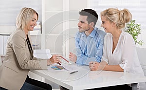 Young couple in a date with a banker or adviser for retirement a photo