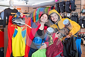 Young couple demonstrating tourist equipment