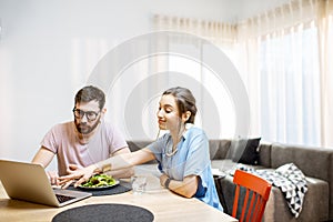 Young couple dinning in the living room