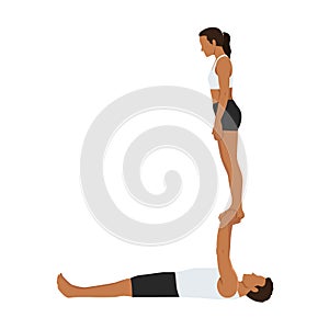 Young couple doing acroyoga. Woman balancing on raised arms of man lying on floor