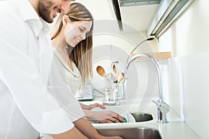 Young couple doing dishes