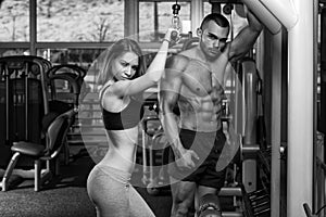 Young Couple Doing Heavy Weight Exercise For Triceps