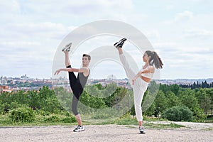 Young couple doing a high kick, street dance, ballet, dancing steps, movements