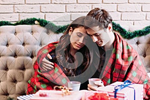 Young couple dreaming together with hot chocolate