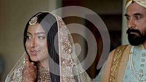 Young Couple Dressed In Arabic Style. Man In Blue Suit And Headdress Approaches The Girl And Kisses Her On The Head.