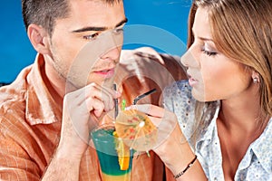 Young couple drinking cocktail