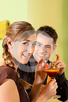 Young couple drinking cocktails