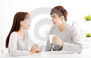 young Couple drinking coffee In living room