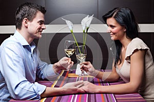 Young couple drinking wine and flirting