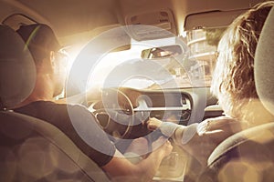 Young couple driving in a car