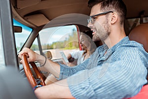 young couple driving car during