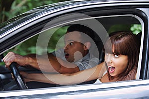 Young couple driving car