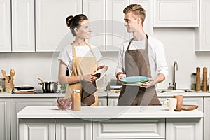 young couple drying dishes