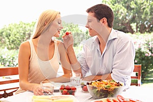 Young couple eating outdoors