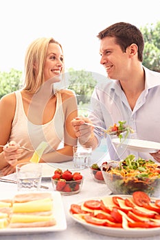 Young couple eating outdoors