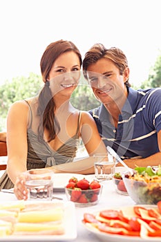 Young couple eating outdoors