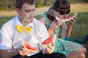 Young couple eating watermelon