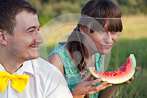 Young couple eating watermelon