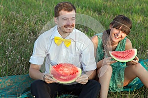 Young couple eating watermelon