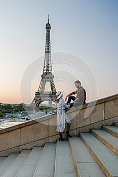 Young couple by Eiffel tower at Sunrise, Paris Eifel tower Sunrise man woman in love, valentine concept in Paris the