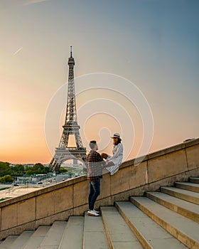 Young couple by Eiffel tower at Sunrise, Paris Eifel tower Sunrise man woman in love, valentine concept in Paris the