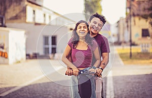 Young couple on electric scooter Funny couple