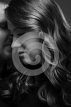 Young couple embrace tenderly and sensually. Black and white photo. Vertical. Close-up
