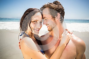 Young couple embracing each other on the beach