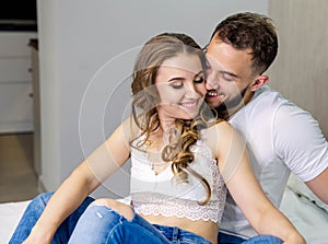 Young couple embracing and having romantic time in bedroom together