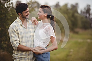 Young couple embracing at olive farm