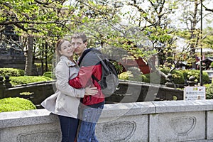 Young couple embracing in the Sensoji shrine garden