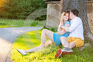 Young Couple Embracing Under Tree