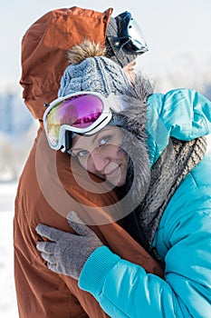 Young couple embracing winter countryside ski snow