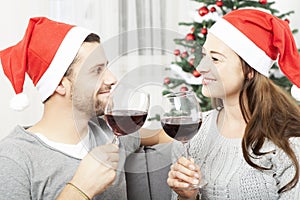 Young couple enjoy chistmas with wine