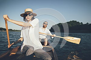 Young couple enjoy summer canoe ride on the lake