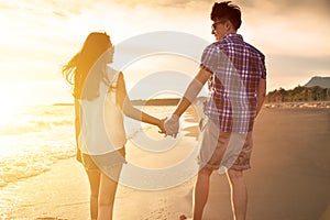 Young couple enjoying a beach walk