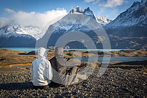 Young couple enjoying the a beautiful scenario in Torres del Paine National Park, Patagonia, Chile