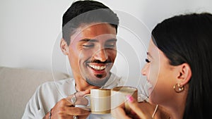 Young couple enjoying coffee on comfy couch closeup. Family talking laughing